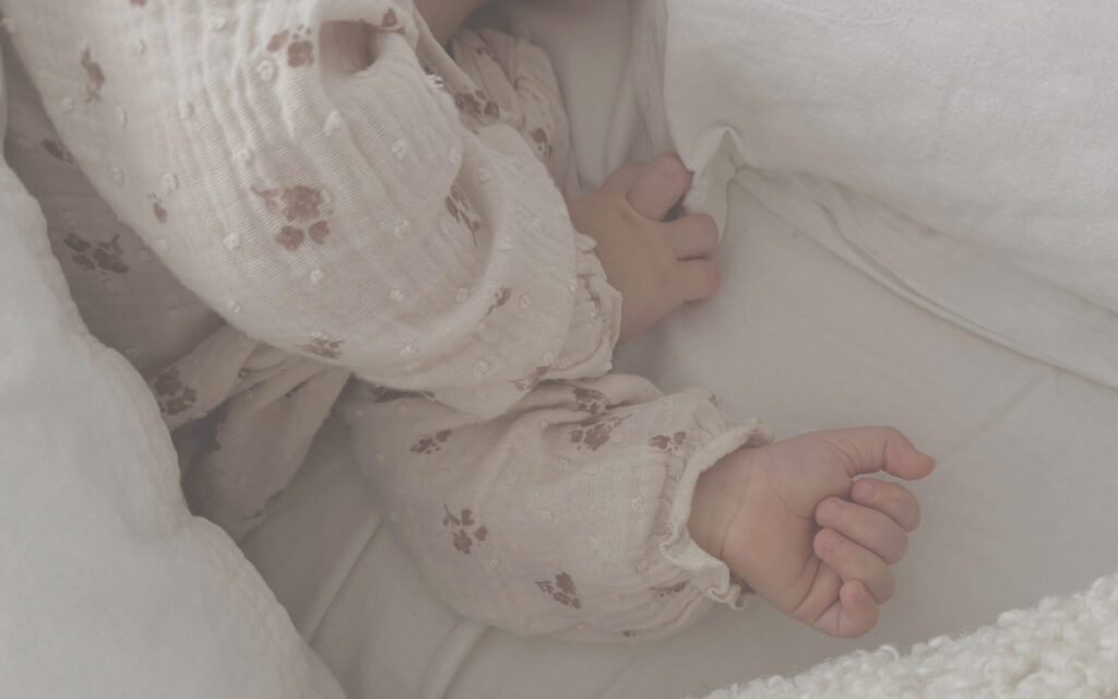 Hero Image - Baby sleeping, wearing a beautiful floral top